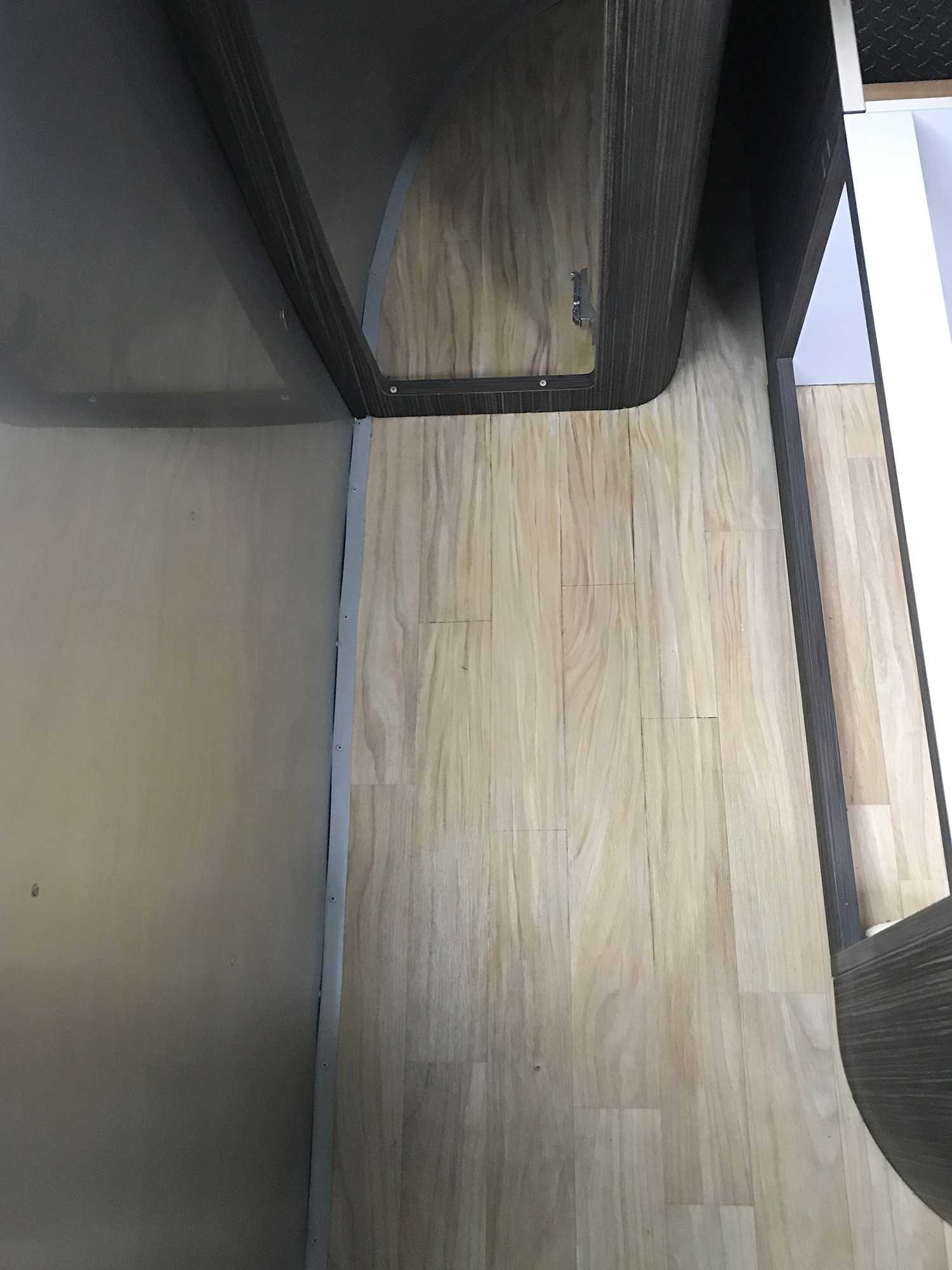 Newly restored light tan vinyl floor with wodden pattern